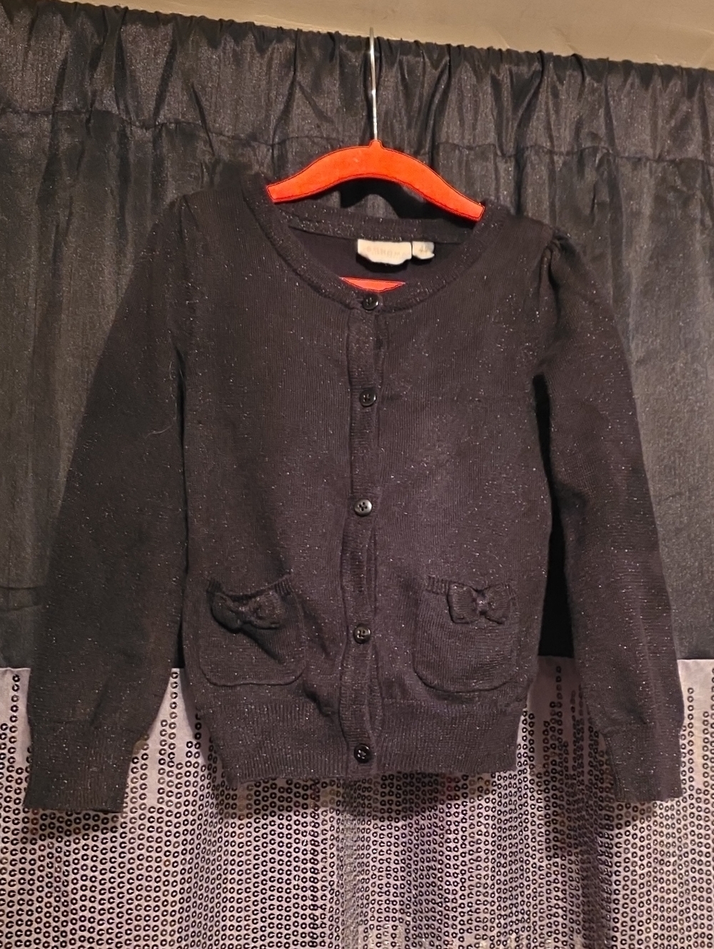 Classic black cardigan with subtle sparkle